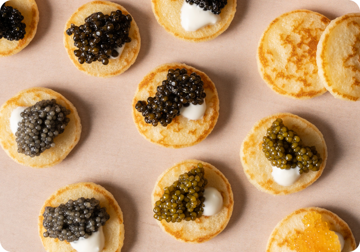 Blinis topped with black, golden and red caviar