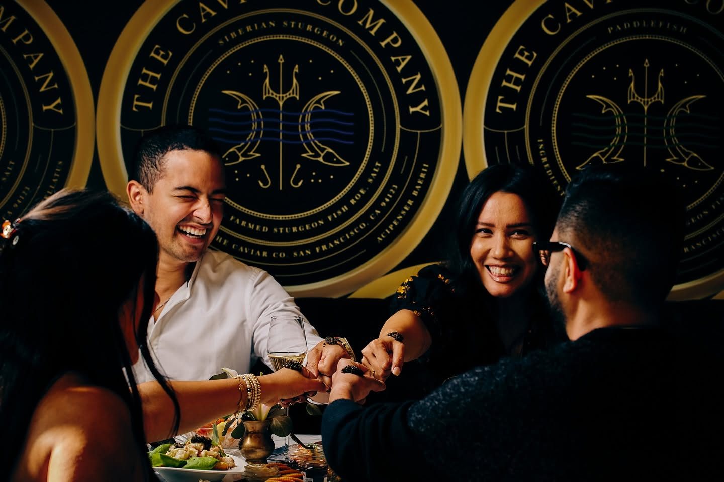Friends toasting with caviar at a holiday party